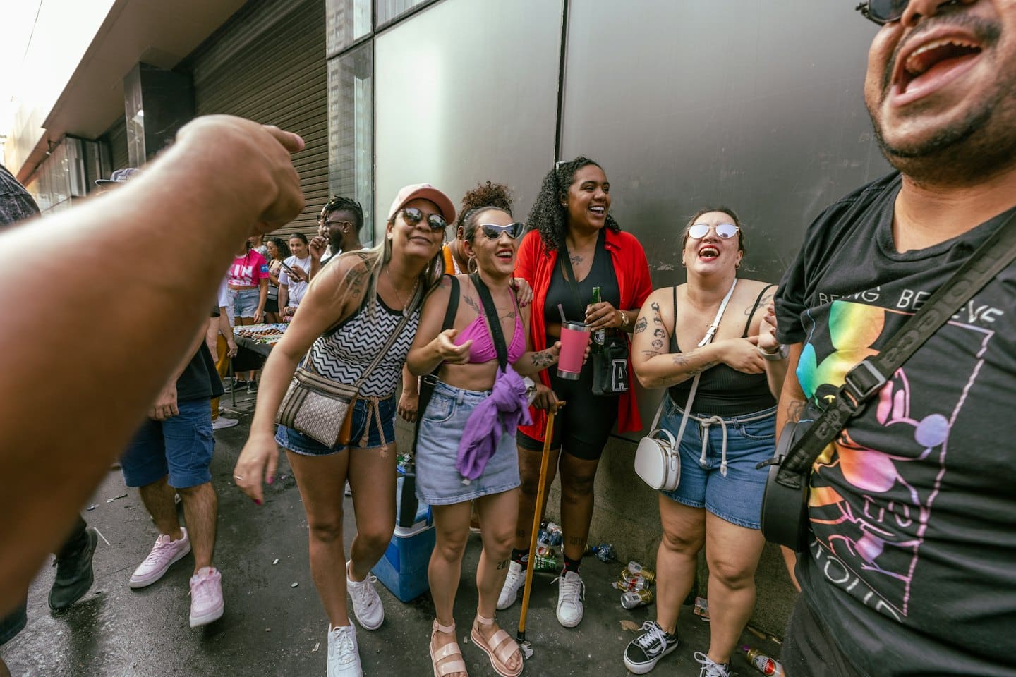 A group of people laughing together on a city street.